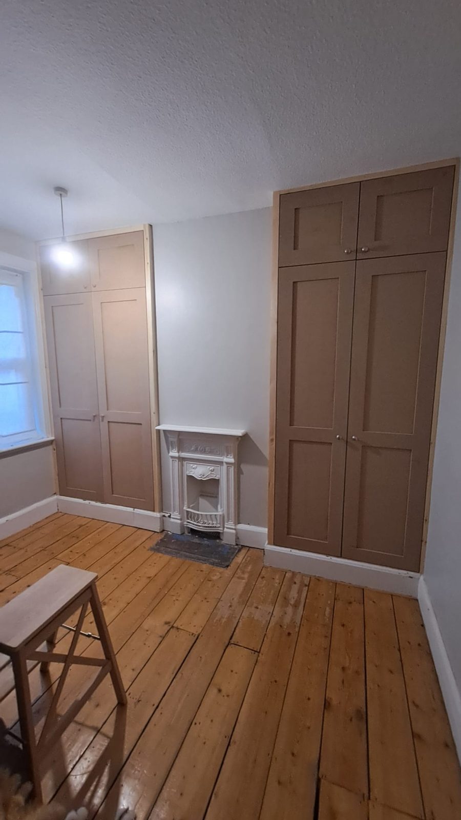 Fitted loft cabinetry making use of every inch of awkward roof space