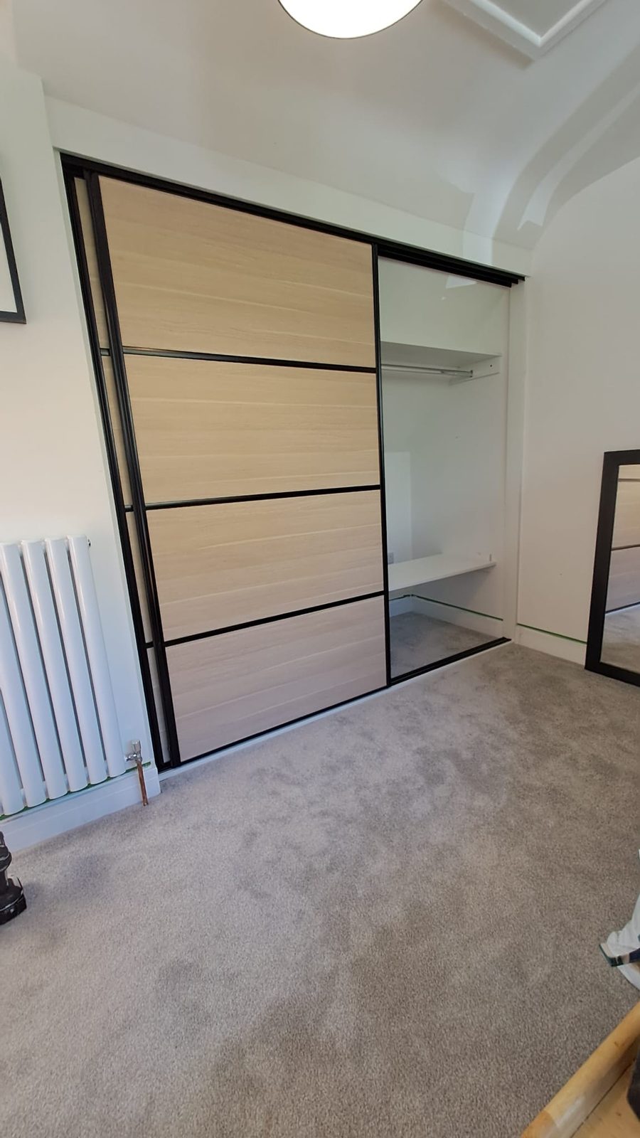 Fitted wardrobes with open shelving, full-width bedroom storage
