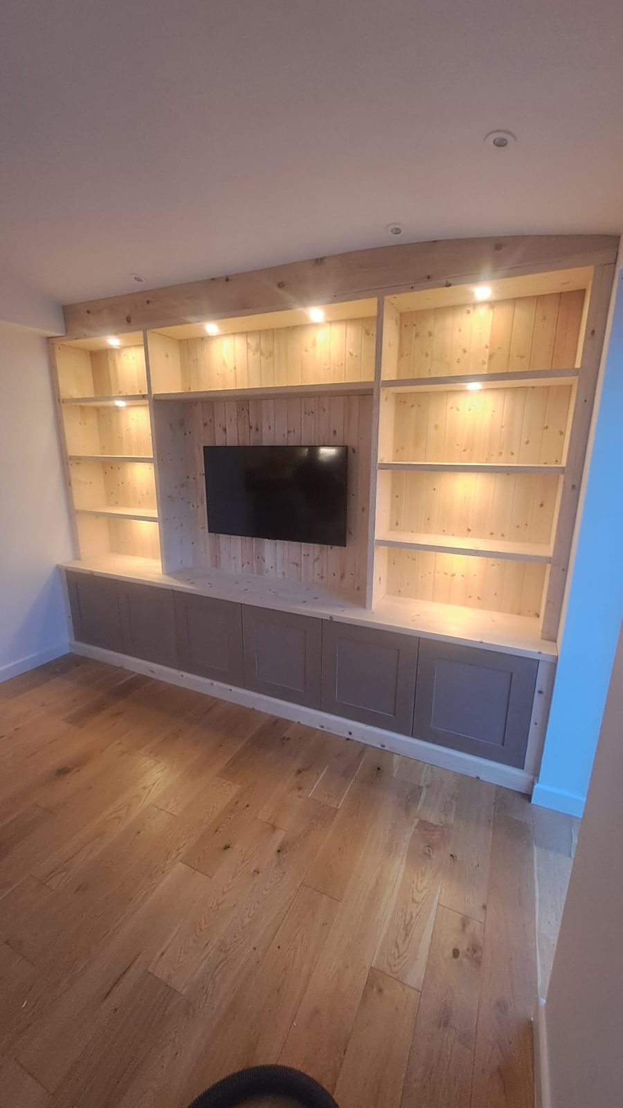 Fitted wardrobes to a sloped ceiling with a hanging rail and pull-out drawers